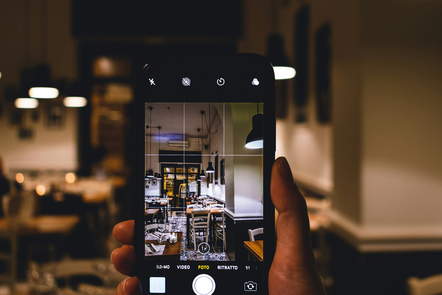 Person taking a photo of a room with a smartphone. Creating content